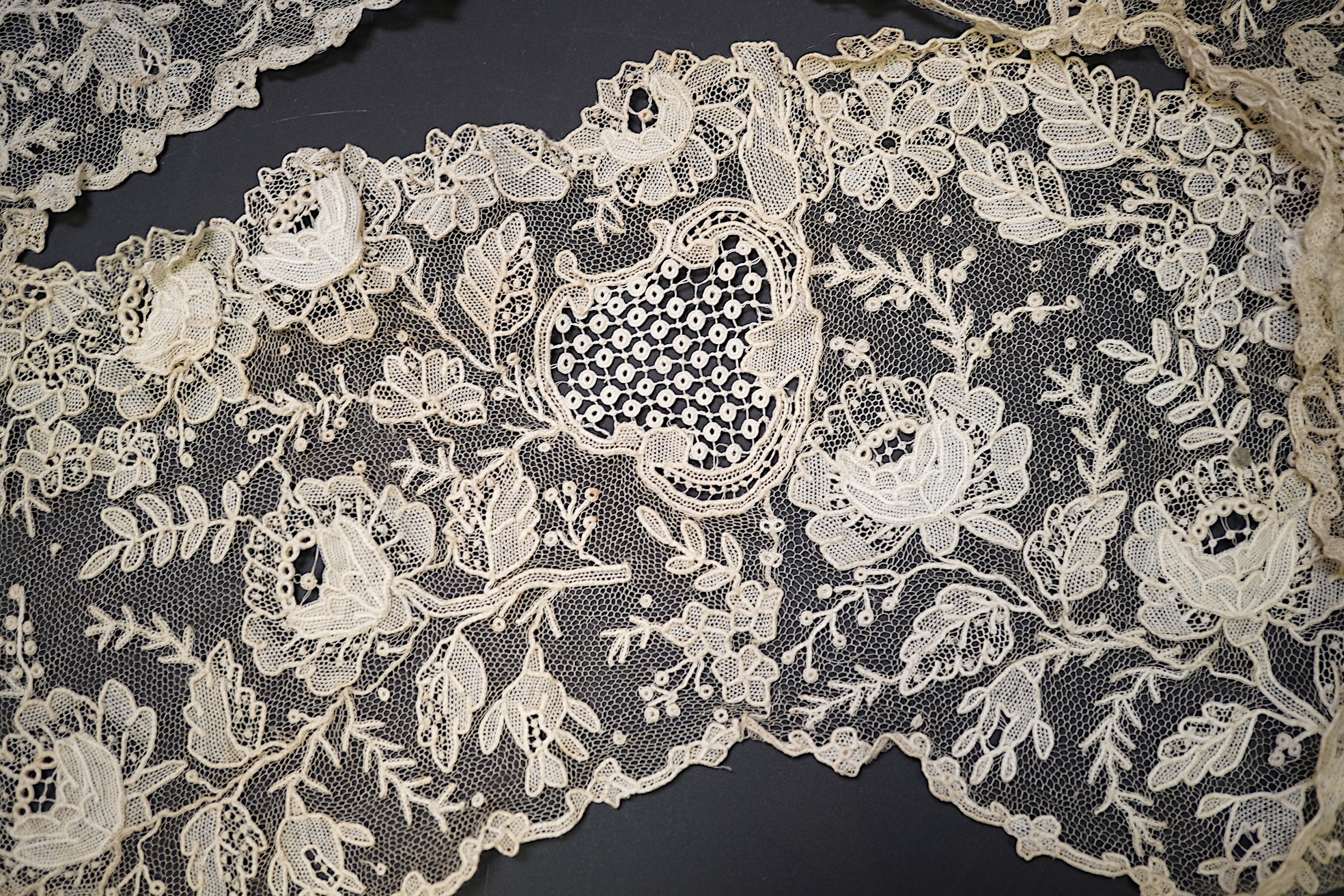 A 19th century Brussels Point de Gaz needle lace collar, lappet and wedding hankie, possibly part of a trousseau. The collar having thirty four needle lace raised flower heads within the design. The collar 100cm long x 1